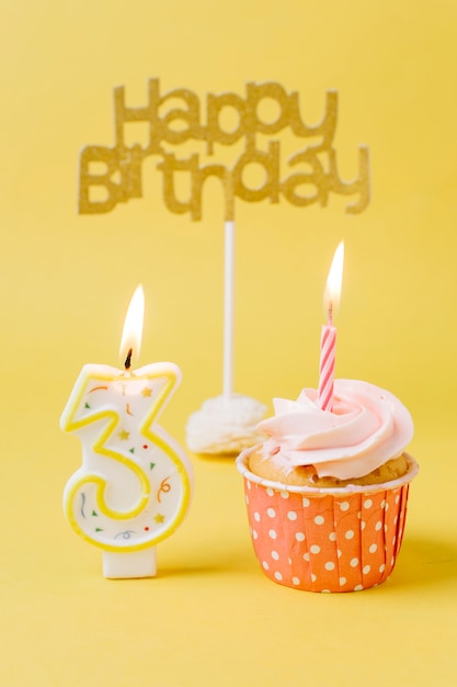 Birthday cupcake with lit candle