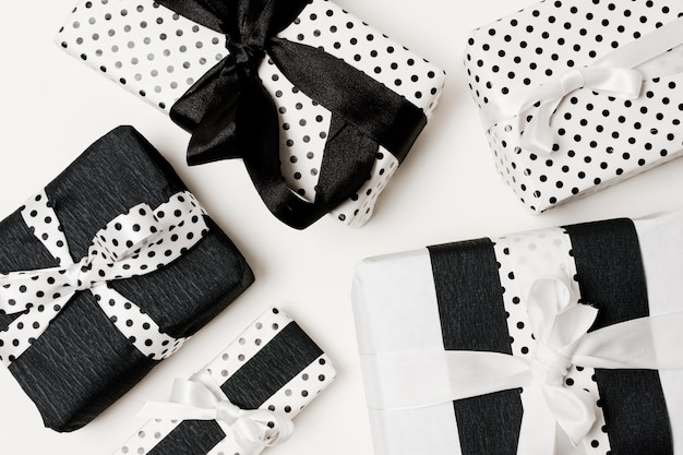 Free photo birthday gifts presents box wrapped with white and black beautiful polka dots paper