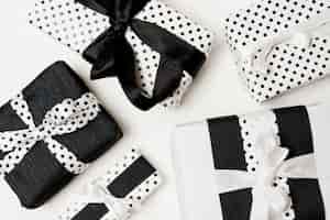 Foto gratuita regali di compleanno presenta scatola avvolta con carta bianca e nera bella a pois