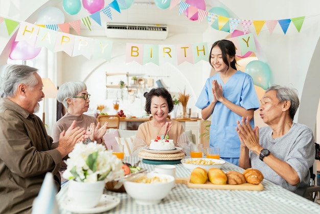 Birthday party at senior daycaregroup of asian female elder male female laugh smile positive conversation greeting in birthday friend party at nursing home senior daycare center Senior woman birthday