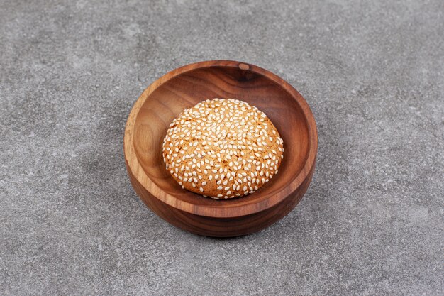 Biscuit with sesame seeds on wooden plate