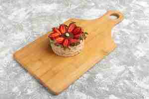 Free photo biscuit with strawberries on wooden desk