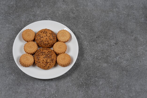 Biscuits and cookie on the plate on the marble surface