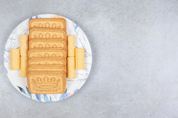 Biscuits lined up on a plate on marble background. High quality photo