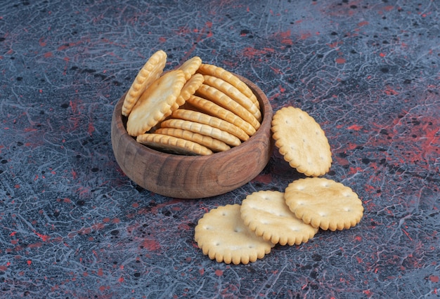 Biscuits in a small bowl on abstract table.