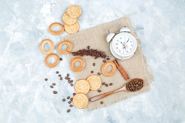Biscuits with coffee beans on grungy background
