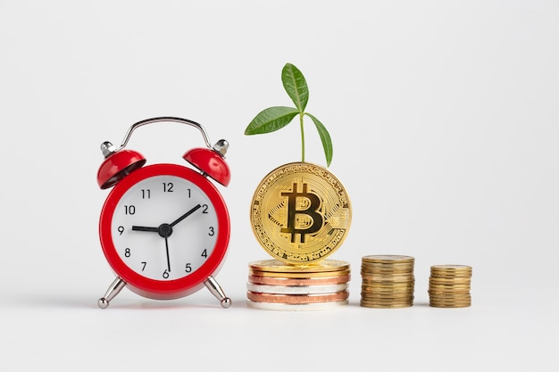 Free photo bitcoin piles next to alarm clock