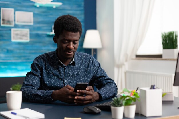 Black african american man using a smartphone at home