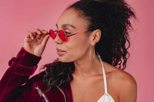 black african american woman in stylish outfit velvet purple jacket and white top on pink