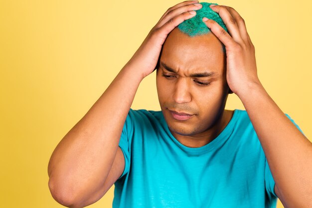 Black african man in casual on yellow wall tired stressful, holding hands on head, having  headache, pain