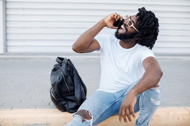 black African man smiling talking on phone outdoor