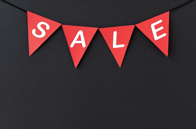 Black background for sales with hanging red flags