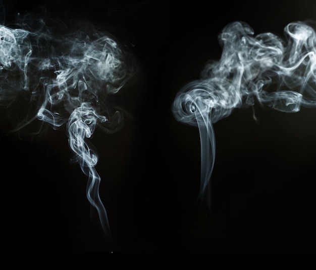 Free photo black background with abstract smoke shapes