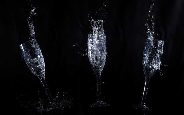 Black background with crystal glasses in motion