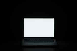 Free photo black background with laptop