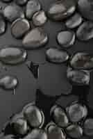 Free photo black background with rocks and water