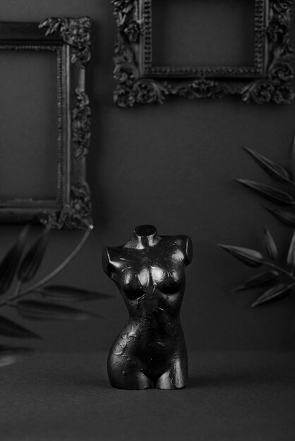 Black background with statue and frames