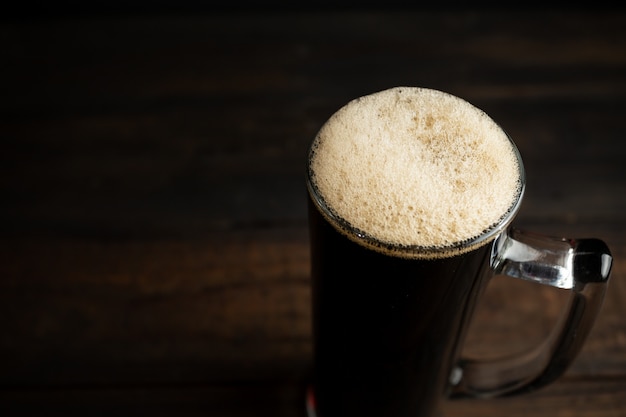 Black beer on wood.