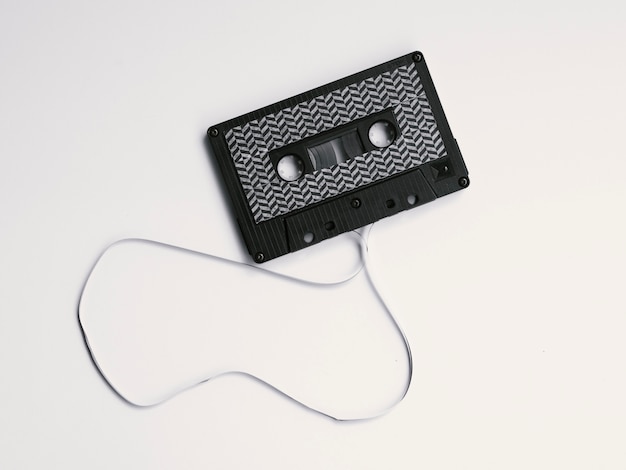 Free photo black boken cassette tape on white background