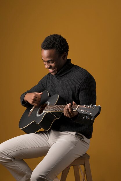 Black boy playing the guitar