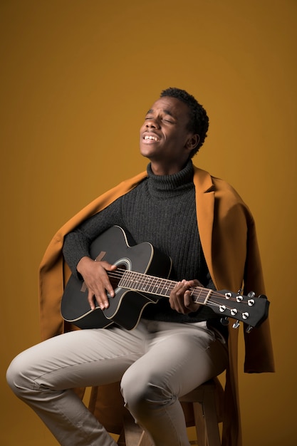 Black boy playing the guitar