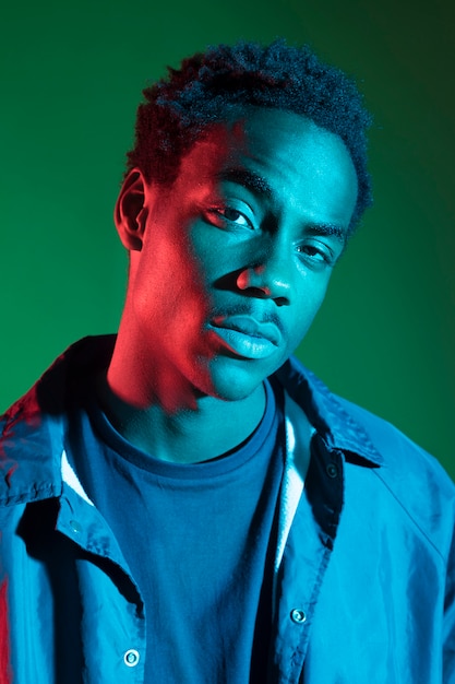 Black boy posing with blue light