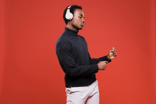 Free photo black boy posing with headphones