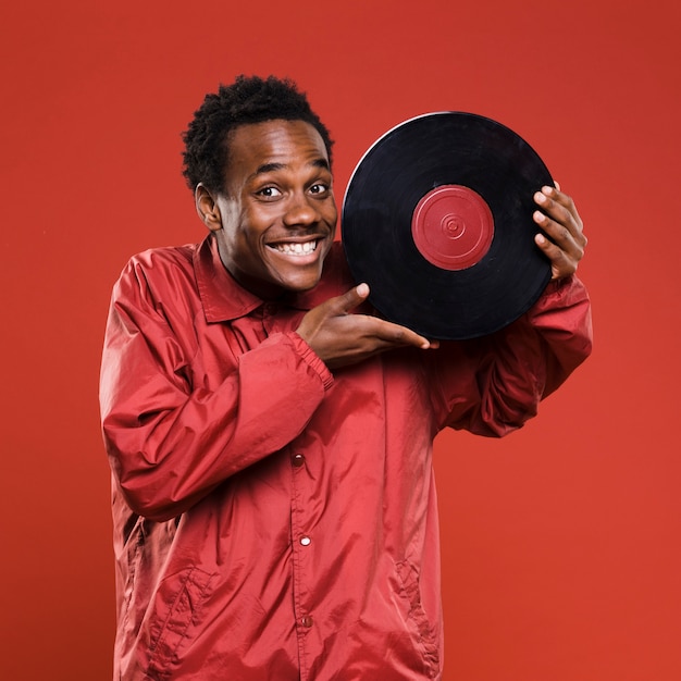 Free photo black boy posing with vinyls