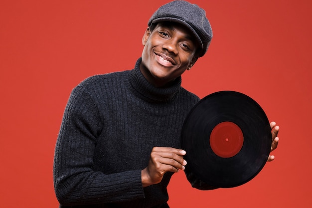 Free photo black boy posing with vinyls