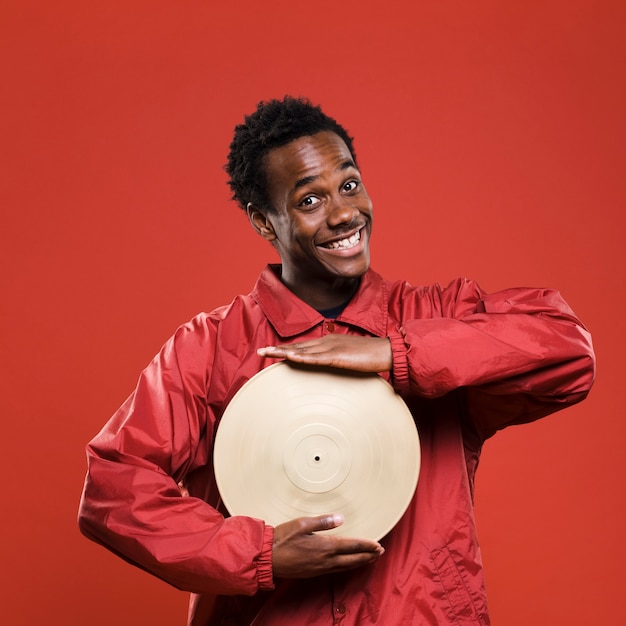 Free photo black boy posing with vinyls