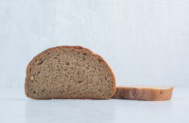 Black bread slices on blue background. High quality photo