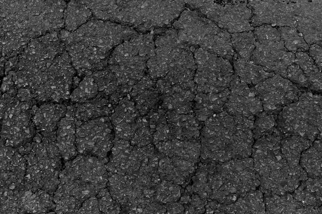 Free photo black broken asphalt texture or background