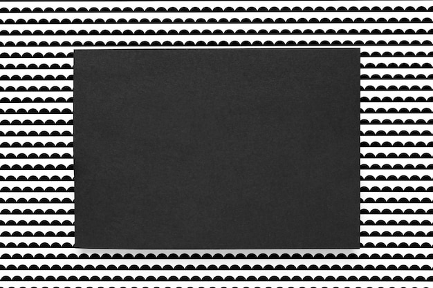 Black card on patterned background