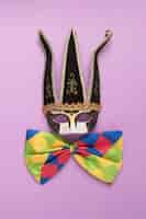 Free photo black carnival mask with colorful bow tie