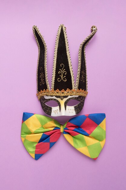 Black carnival mask with colorful bow tie