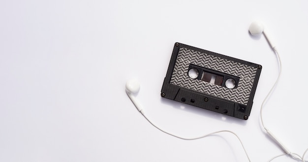 Black cassette tape with earphones and copy-space