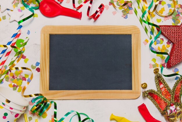 Black chalkboard with party decoration with balloons and confetti