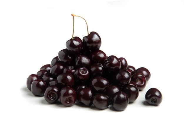 Black cherries isolated on white background