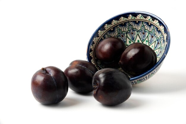 Black cherry plums in an ethnic saucer