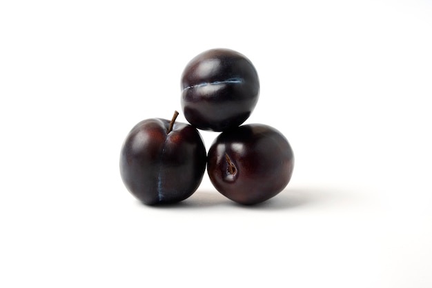 Black cherry plums isolated on white