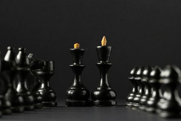 Black chess pieces on black background