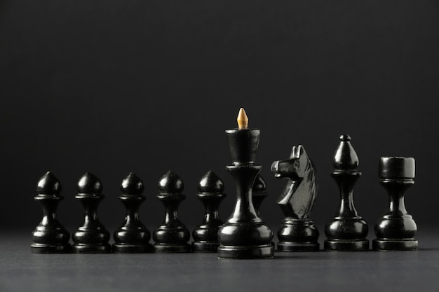 Free photo black chess pieces on black background