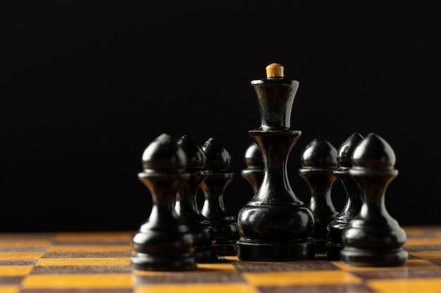 Black chess pieces on chess board.