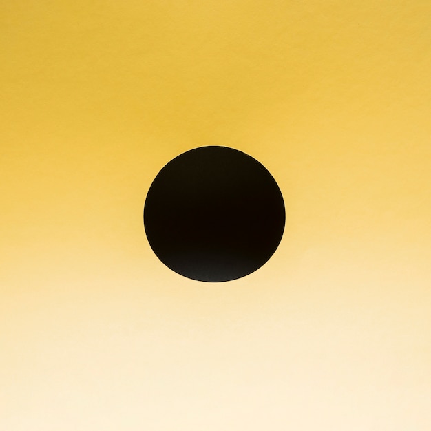 Free photo black circle on a gradient yellow background