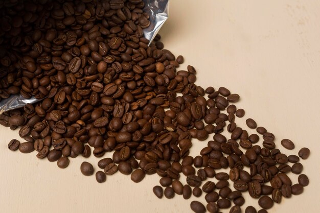 Black coffee beans assortment on beige background