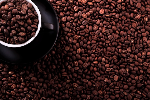 Black coffee cup with roasted beans background