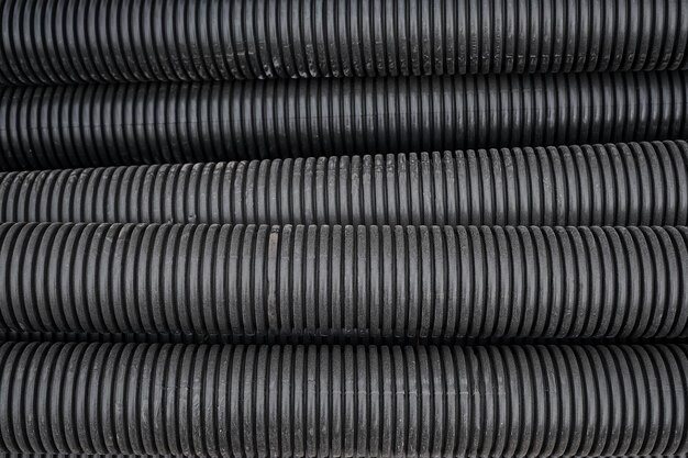 Black construction pipes coated corrugated pipes for road and electrical network repair top view Reconstruction and improvement of the social infrastructure of cities