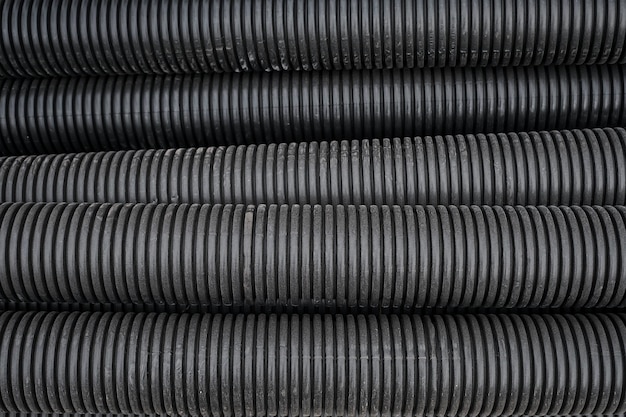 Black construction pipes coated corrugated pipes for road and electrical network repair top view Reconstruction and improvement of the social infrastructure of cities