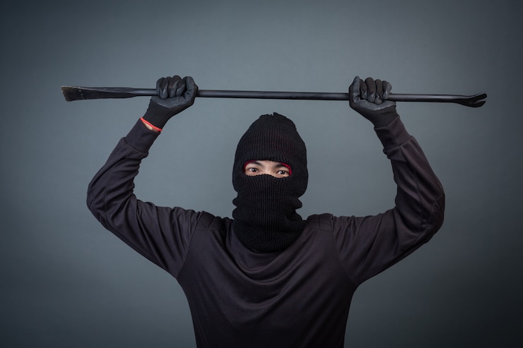 Free Photo black criminals wore a head yarn on gray