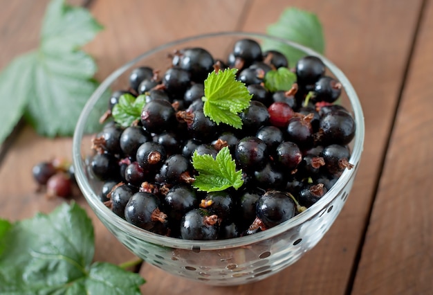 Free photo black currants in a glass bowl